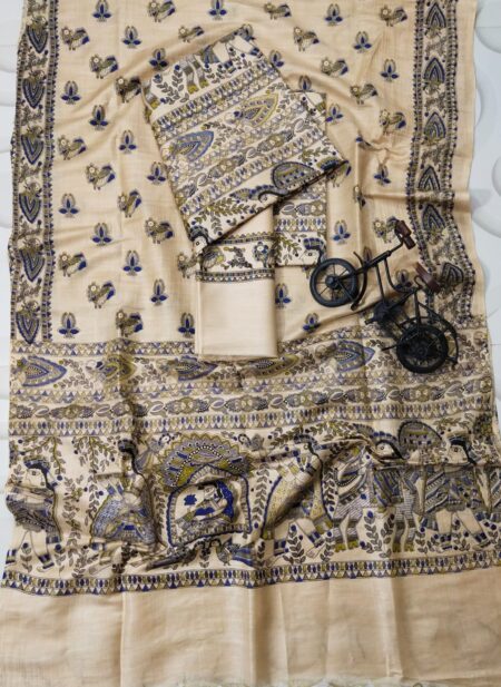 An unstitched cream Katan silk suit material set by Bhavya Lakshmi Fabrics featuring detailed multi-colored Madhubani prints of ceremonial figures, elephants, and peacocks in indigo blue and olive green.
