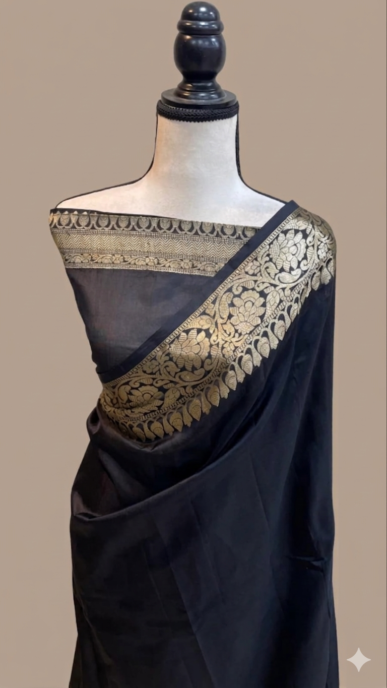 Bhavya lakshmi Fabrics Midnight Black Banarasi Katan Silk Saree | Handloom Gold Zari Border Midnight black Banarasi Katan silk saree with a plain solid body and a broad traditional gold zari floral border