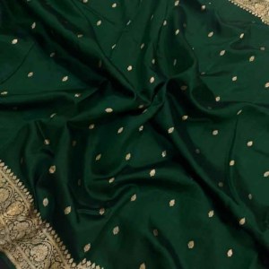 A semi-sheer Bottle Green Organza Banarasi Saree from Bhavya Lakshmi Fabrics, featuring handwoven golden zari butis and a detailed floral border.