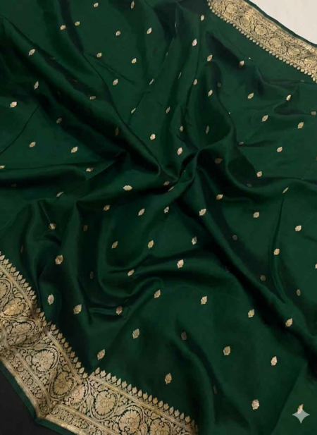 A semi-sheer Bottle Green Organza Banarasi Saree from Bhavya Lakshmi Fabrics, featuring handwoven golden zari butis and a detailed floral border.