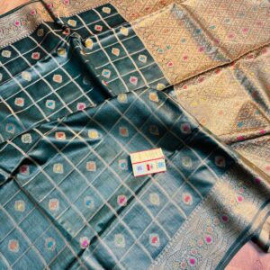 Vibrant bottle green pure Bhagalpuri Munga silk saree from Bhavya Lakshmi Fabrics featuring gold zari checks with multi-color floral Meenakari butis and an intricate gold zari border, spread on a wooden floor.