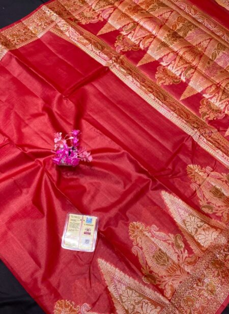 A vibrant crimson red Tussar Banarasi silk saree featuring a thick gold zari border and a heavily woven pallu with traditional floral and paisley motifs.