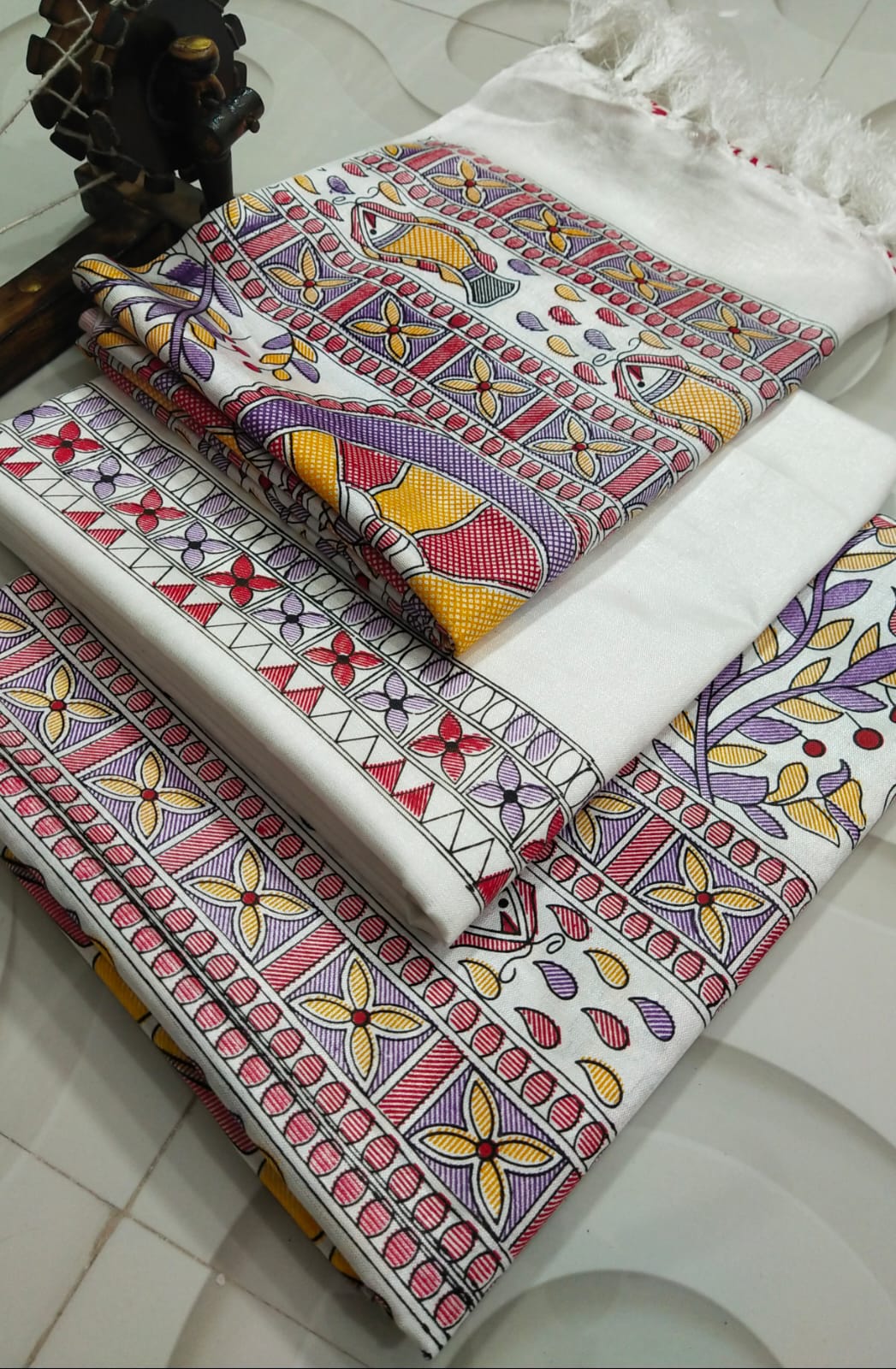 Dupion Slub Fabric Madhubani Purple & Yellow Print Suit Set Bhavya Lakshmi Fabrics 111 Off-white dupion slub silk unstitched suit material featuring traditional purple, yellow, and red Madhubani fish and tree prints.