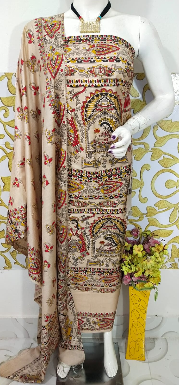 Beige and Terracotta Madhubani Print Unstitched Katan Silk Suit Material A premium unstitched beige Katan silk suit material set by Bhavya Lakshmi Fabrics featuring detailed multicolored Madhubani art prints of fluting deities, birds, and fish on a clean, minimal off-white backdrop.