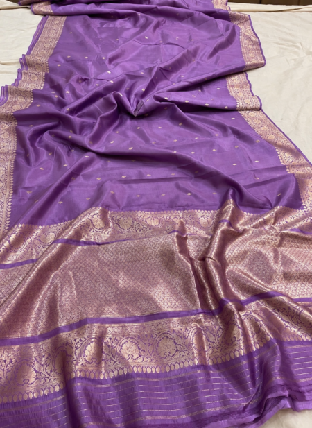 A full-length view of a luxurious Mauve Purple Organza Banarasi Saree from Bhavya Lakshmi Fabrics displaying delicate golden zari butis and a grandly detailed floral zari pallu.