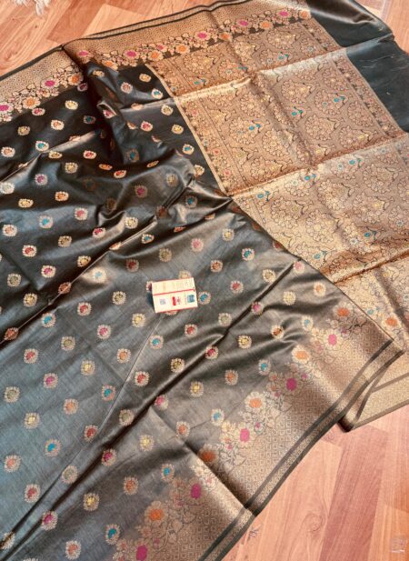 Sophisticated midnight black pure Bhagalpuri Munga silk saree from Bhavya Lakshmi Fabrics featuring multi-color floral butis and an intricate gold zari border