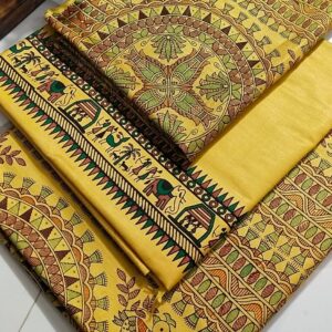 An unstitched mustard yellow Katan silk suit material set by Bhavya Lakshmi Fabrics featuring extensive multi-colored Madhubani prints of ceremonial elephants, ritual huts, and stylized birds with geometric circular borders.
