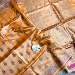 Vibrant mustard yellow pure Bhagalpuri Munga silk saree from Bhavya Lakshmi Fabrics featuring multi-color floral butis and an intricate gold zari border