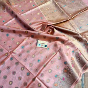 Elegant pastel peach pure Bhagalpuri Muga silk saree from Bhavya Lakshmi Fabrics featuring multi-color floral butis and an intricate gold zari border