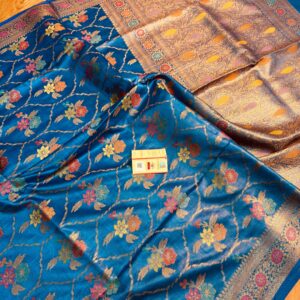 Vibrant peacock blue pure Bhagalpuri Munga silk saree from Bhavya Lakshmi Fabrics featuring a multi-color floral Meenakari jaal and an intricate gold zari border