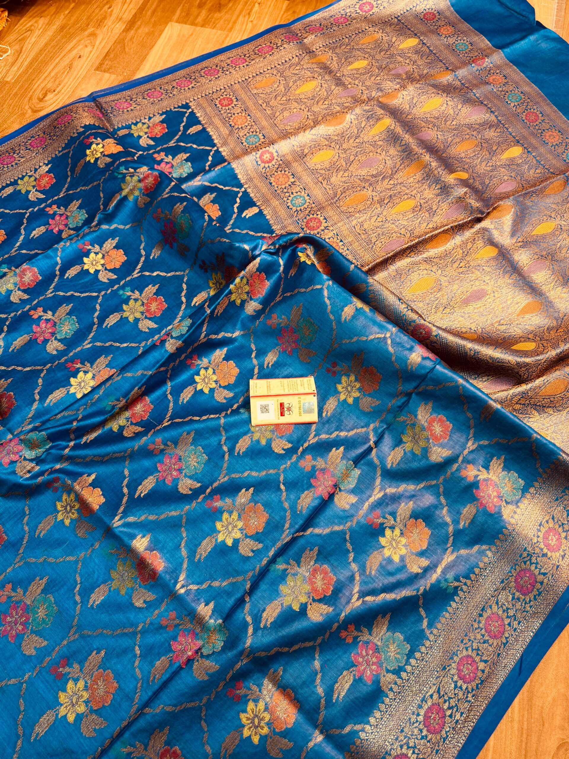 Peacock Blue Pure Bhagalpuri Munga Silk Saree by Bhavya Lakshmi Fabrics (2) Vibrant peacock blue pure Bhagalpuri Munga silk saree from Bhavya Lakshmi Fabrics featuring a multi-color floral Meenakari jaal and an intricate gold zari border
