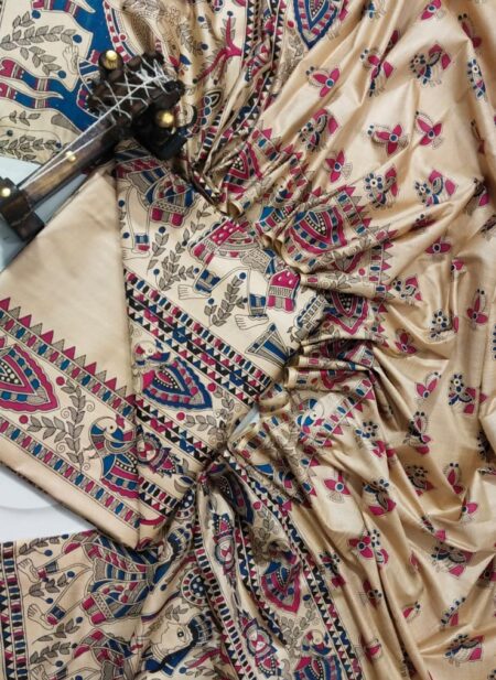 An unstitched cream Katan silk suit material set by Bhavya Lakshmi Fabrics featuring detailed multi-colored Madhubani prints of ceremonial elephants, peacocks, and floral creepers in magenta pink and indigo blue.