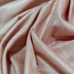 Sophisticated rose gold peach pure Tussar Munga silk fabric with a rich, textured weave for premium menswear.