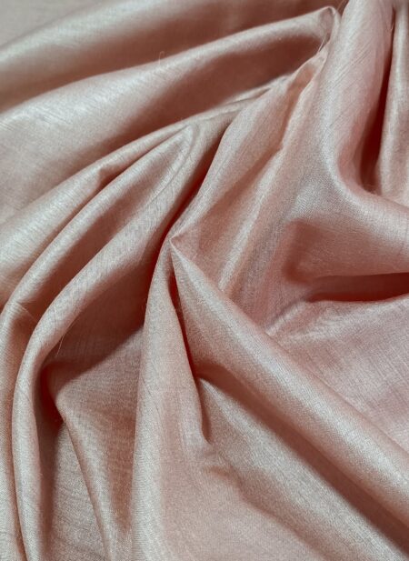 Sophisticated rose gold peach pure Tussar Munga silk fabric with a rich, textured weave for premium menswear.