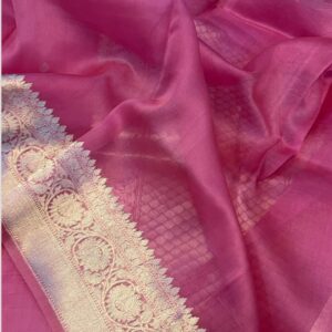 A close-up view of a vibrant Rani Pink Organza Banarasi Saree from Bhavya Lakshmi Fabrics featuring detailed handwoven silver zari floral borders and subtle self-textured check patterns.