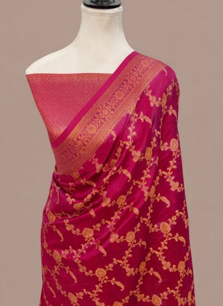 Magenta pink Banarasi Katan silk saree with an all-over gold zari floral jaal pattern and a decorative zari border