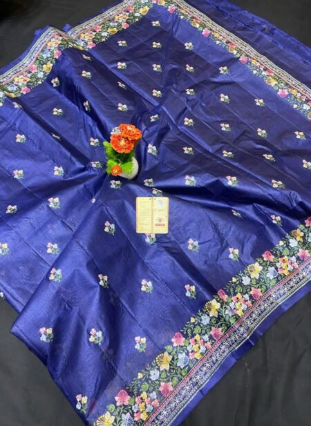 A royal navy blue pure Bhagalpuri Munga silk handloom saree from Bhavya Lakshmi Fabrics featuring detailed multicolored floral embroidery scattered butis and an ornate floral border.