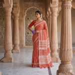 Sophisticated rust orange linen blend Bhagalpuri saree featuring white geometric Bagru prints and elegant pompom tassels.