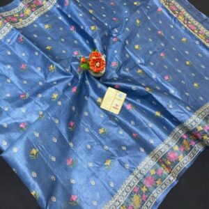 A steel blue pure Bhagalpuri Munga silk handloom saree from Bhavya Lakshmi Fabrics featuring detailed multicolored floral embroidery scattered butis and an ornate floral border.