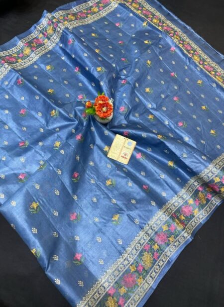 A steel blue pure Bhagalpuri Munga silk handloom saree from Bhavya Lakshmi Fabrics featuring detailed multicolored floral embroidery scattered butis and an ornate floral border.