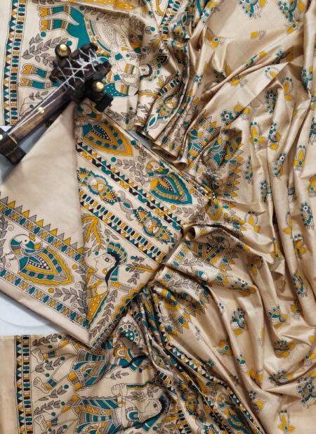 An unstitched cream Katan silk suit material set by Bhavya Lakshmi Fabrics featuring detailed multi-colored Madhubani prints of royal elephants, peacocks, and human figures in teal blue and mustard yellow.