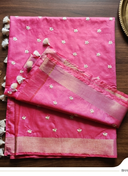 A vibrant pink Kota silk saree from Bhavya Lakshmi Fabrics featuring detailed silver and gold embroidered butis, a woven zari border, and elegant white edge tassels.