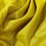 Vibrant golden yellow Tussar Munga pure silk fabric with a rich texture, ideal for premium men's ethnic wear.