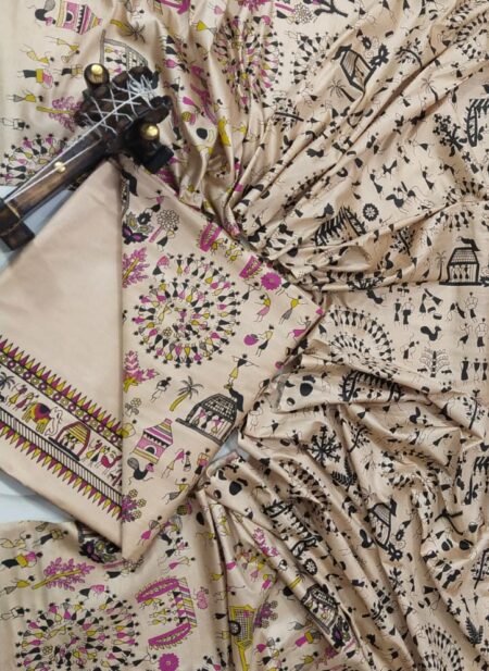 An unstitched beige Katan silk suit material set by Bhavya Lakshmi Fabrics featuring detailed black and magenta Warli tribal dance prints, geometric borders, and a matching dupatta.