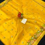 A vibrant yellow pure Bhagalpuri Munga silk handloom saree from Bhavya Lakshmi Fabrics featuring detailed multicolored floral embroidery scattered butis and an ornate floral border.