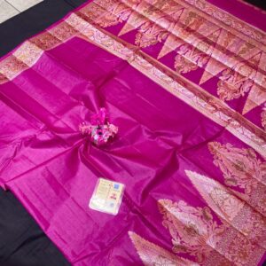 A bright magenta Pure Tussar silk saree with a wide gold zari border featuring floral Meenakari work and a heavily woven pallu with large paisley motifs.