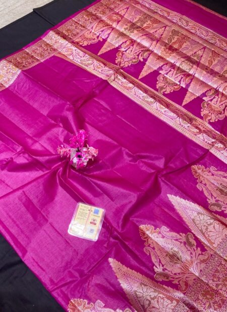 A bright magenta Pure Tussar silk saree with a wide gold zari border featuring floral Meenakari work and a heavily woven pallu with large paisley motifs.