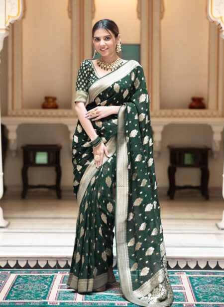 Elegant bottle green semi organza saree featuring woven golden zari floral buttas and a matching patterned blouse.