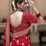 Vibrant bridal red semi organza saree featuring woven golden zari floral buttas and a matching patterned blouse.