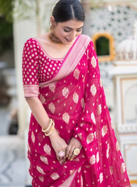 Vibrant rani pink semi organza saree featuring woven golden zari floral buttas and a matching patterned blouse.