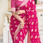 Vibrant rani pink semi organza saree featuring woven golden zari floral buttas and a matching patterned blouse.