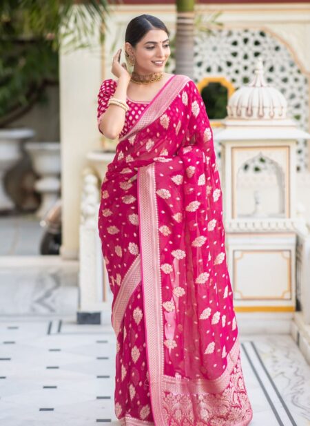 Vibrant rani pink semi organza saree featuring woven golden zari floral buttas and a matching patterned blouse.