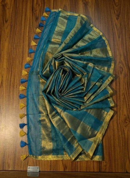Sophisticated teal blue and metallic gold zari striped tissue silk saree featuring intricate borders and matching tassel details.