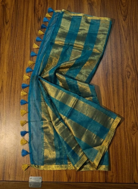 Sophisticated teal blue and metallic gold zari striped tissue silk saree featuring intricate borders and matching tassel details.