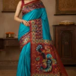 Bhavyaloom turquoise blue premium kota viscose saree with maroon kalamkari border and peacock motif pallu front view